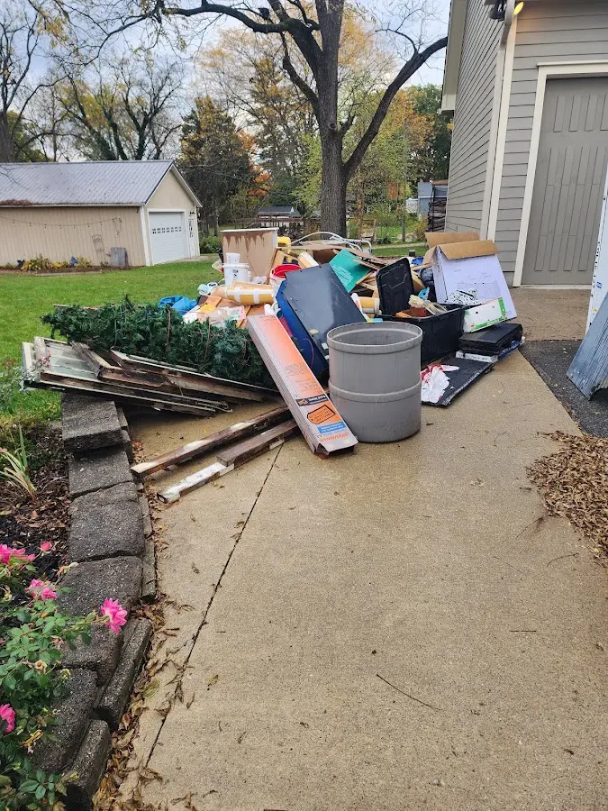 Dumpster being loaded with debris for Estate Cleanout Dumpster Rental in Tomball